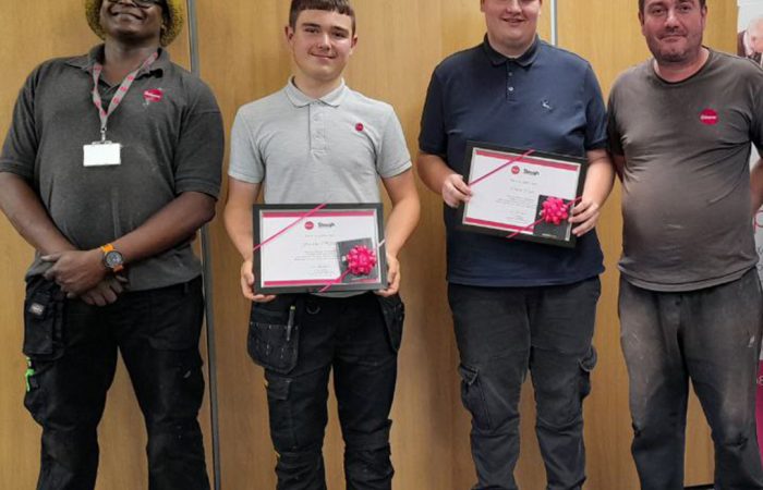 Operatives with work experience students receiving their certificates